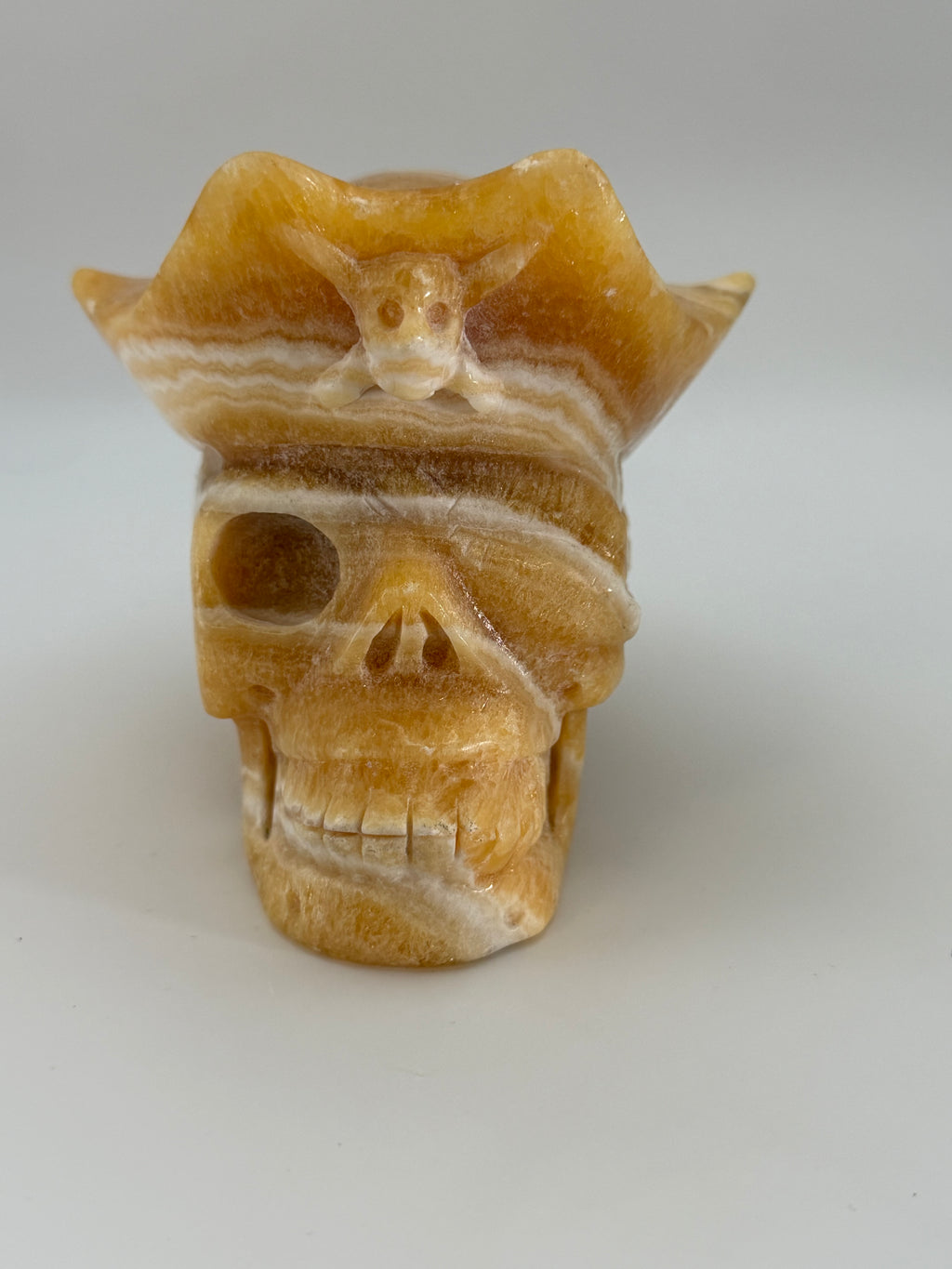 Honey Calcite Skull with Pirate Hat Carving
