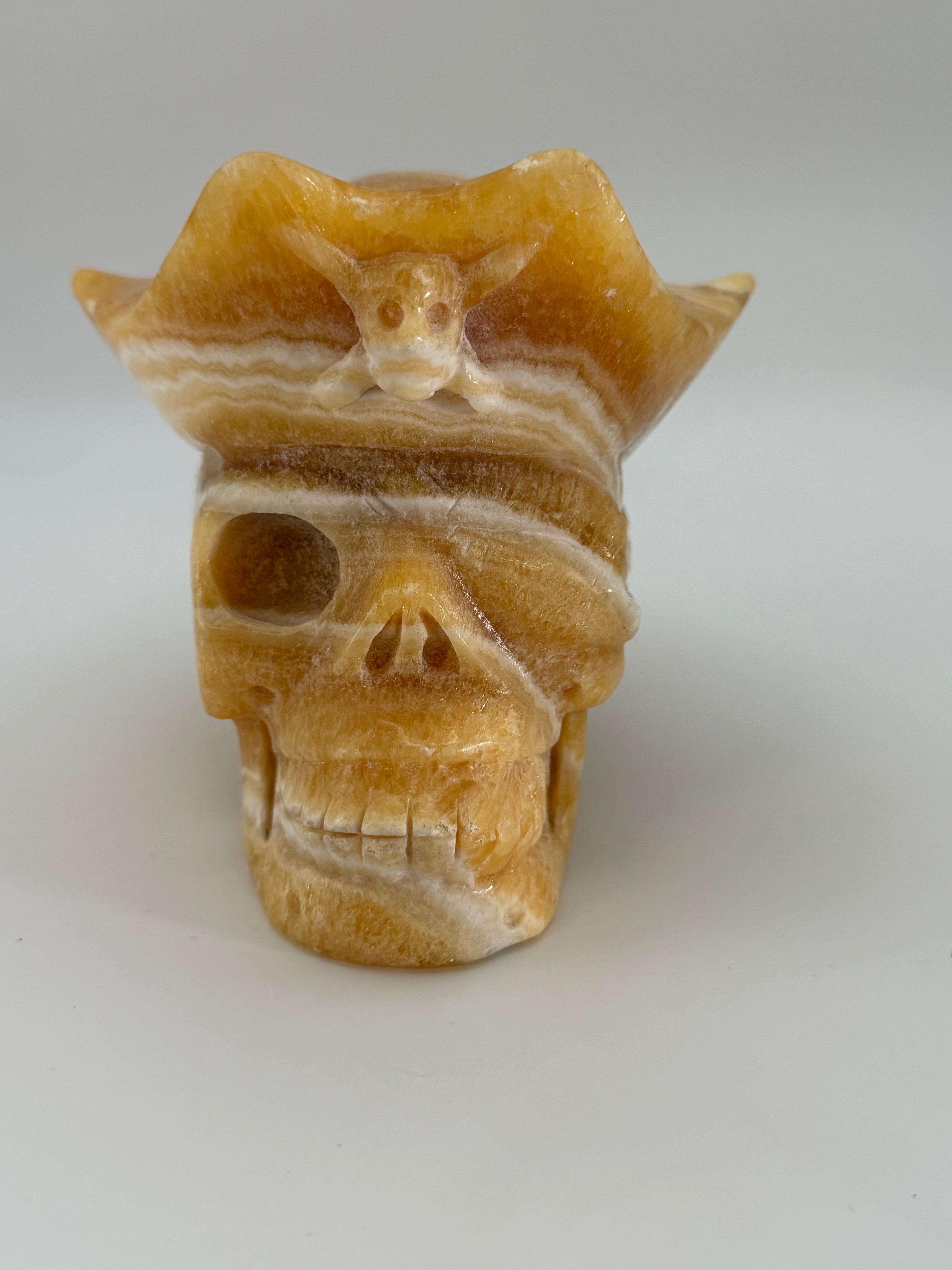 Honey Calcite Skull with Pirate Hat Carving