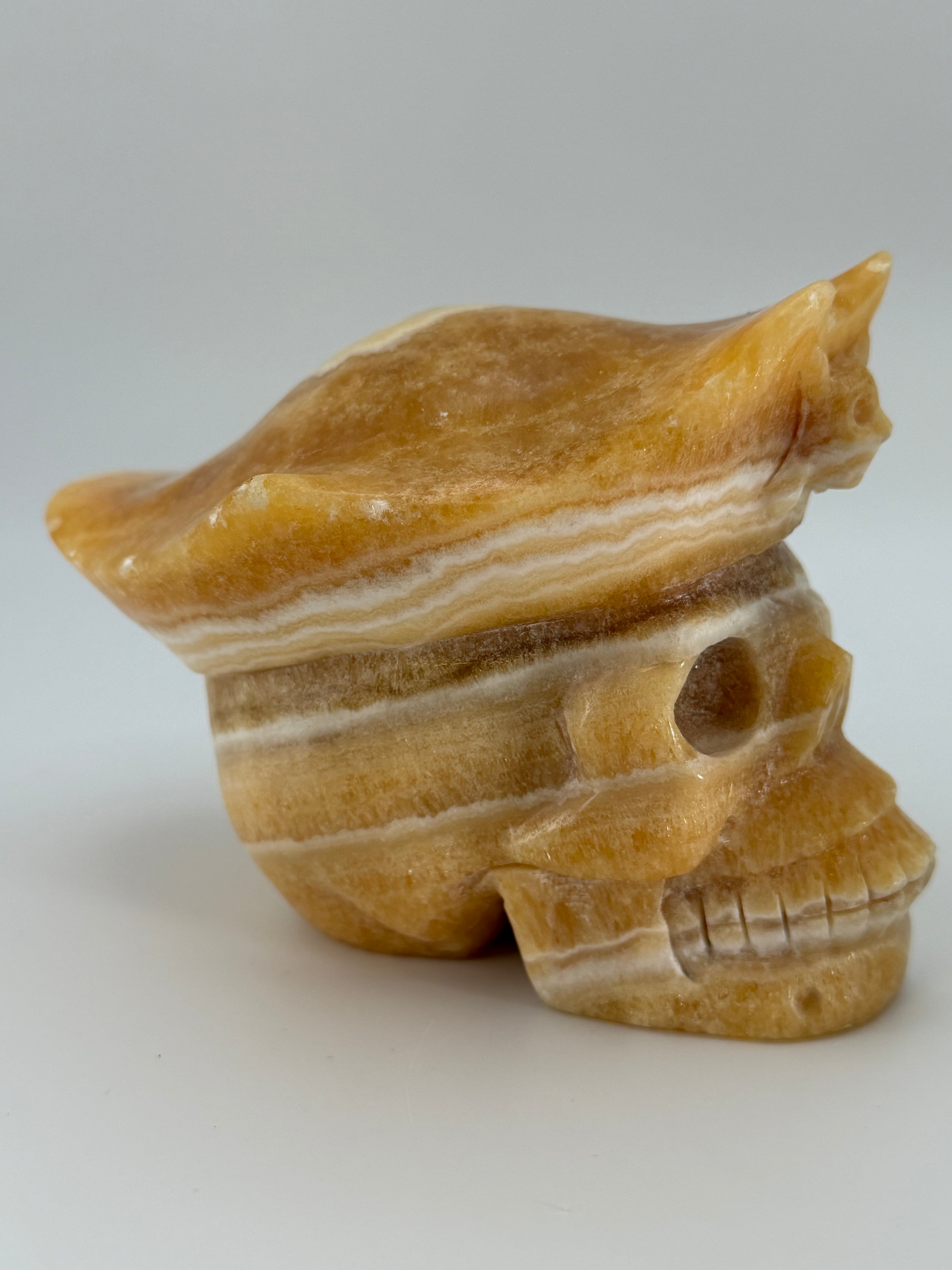 Honey Calcite Skull with Pirate Hat Carving